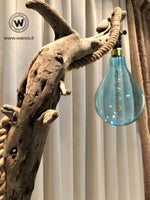 Design floor lamp made of raw wood on a corten-effect iron structure.