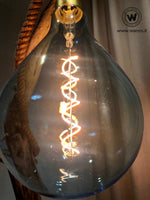 Design floor lamp made of raw wood on a corten-effect iron structure.
