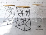 Design stool made of metal with seat in solid natural oak