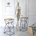 Design stool made of metal with seat in solid natural oak