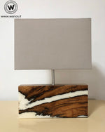 Design table lamp made of solid chestnut wood and white resin.