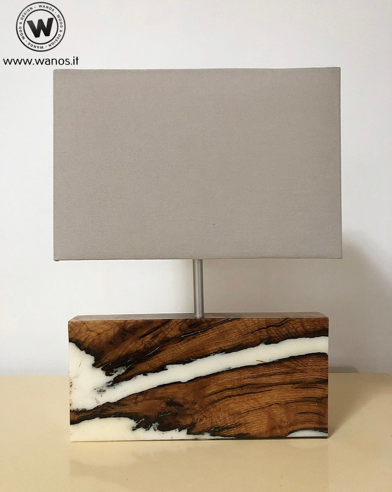 Design table lamp made of solid chestnut wood and white resin.