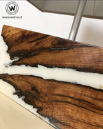 Design table lamp made of solid chestnut wood and white resin.