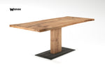 Design table made of solid oak wood on a central metal structure in wood and metal