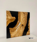 Design wall clock made of solid chestnut wood immersed in marbled blue resin