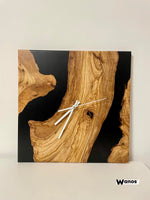 Design wall clock made of solid chestnut wood immersed in marbled blue resin