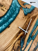 Design wall clock made of solid chestnut wood immersed in marbled blue resin