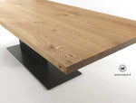 Design table made of solid chestnut wood on a matt black handcrafted iron structure