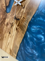 Design wall clock made of solid centuries-old olive wood immersed in aquamarine colored resin