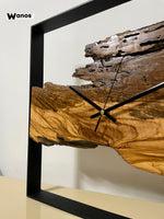 Design wall clock made of solid antique olive wood on a matt black metal structure