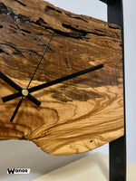 Design wall clock made of solid antique olive wood on a matt black metal structure