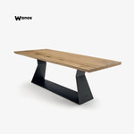 Design table in solid natural chestnut wood on a metal base with an irregular edge