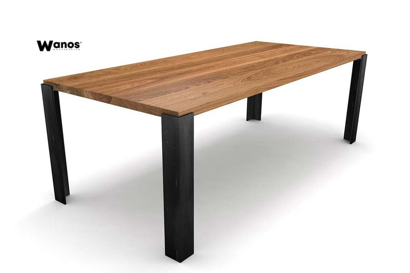 Design table made of solid oak on a minimal metal structure