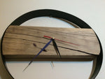 Circular wall clock in solid wood and handcrafted iron in a modern style