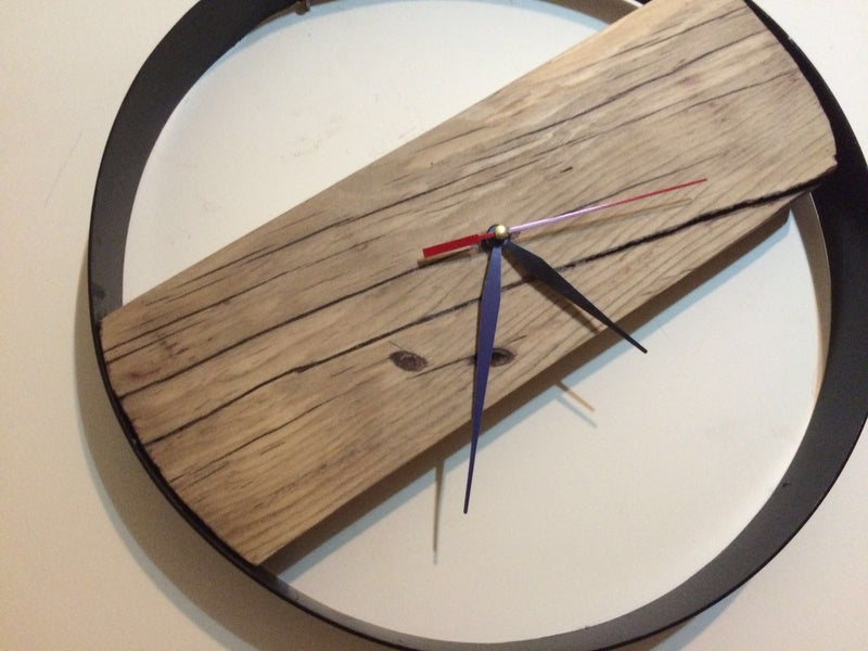 Circular wall clock in solid wood and handcrafted iron in a modern style