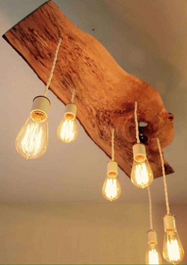 Design chandelier made of irregular debarked chestnut wood with six light points